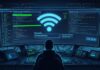 Cara Mencari Password WiFi Dengan CMD di Windows, MacOS, Android & iPhone Seorang profesional IT menganalisis status keamanan jaringan dengan tampilan kode dan indikator kerentanan di layar komputer.