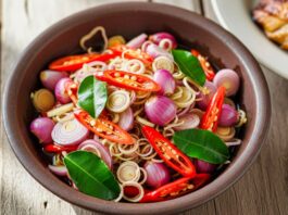 Resep Sambal Matah segar dengan rempah-rempah khas, seperti cabai merah, serai, dan daun jeruk, menambah aroma masakan Indonesia.